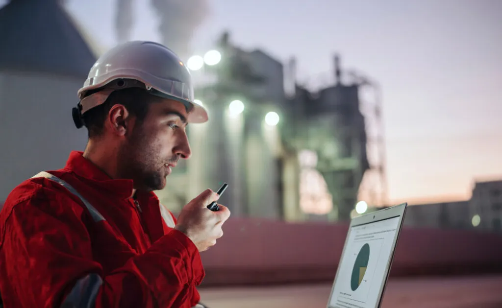 Tech in hardhat on a radio
